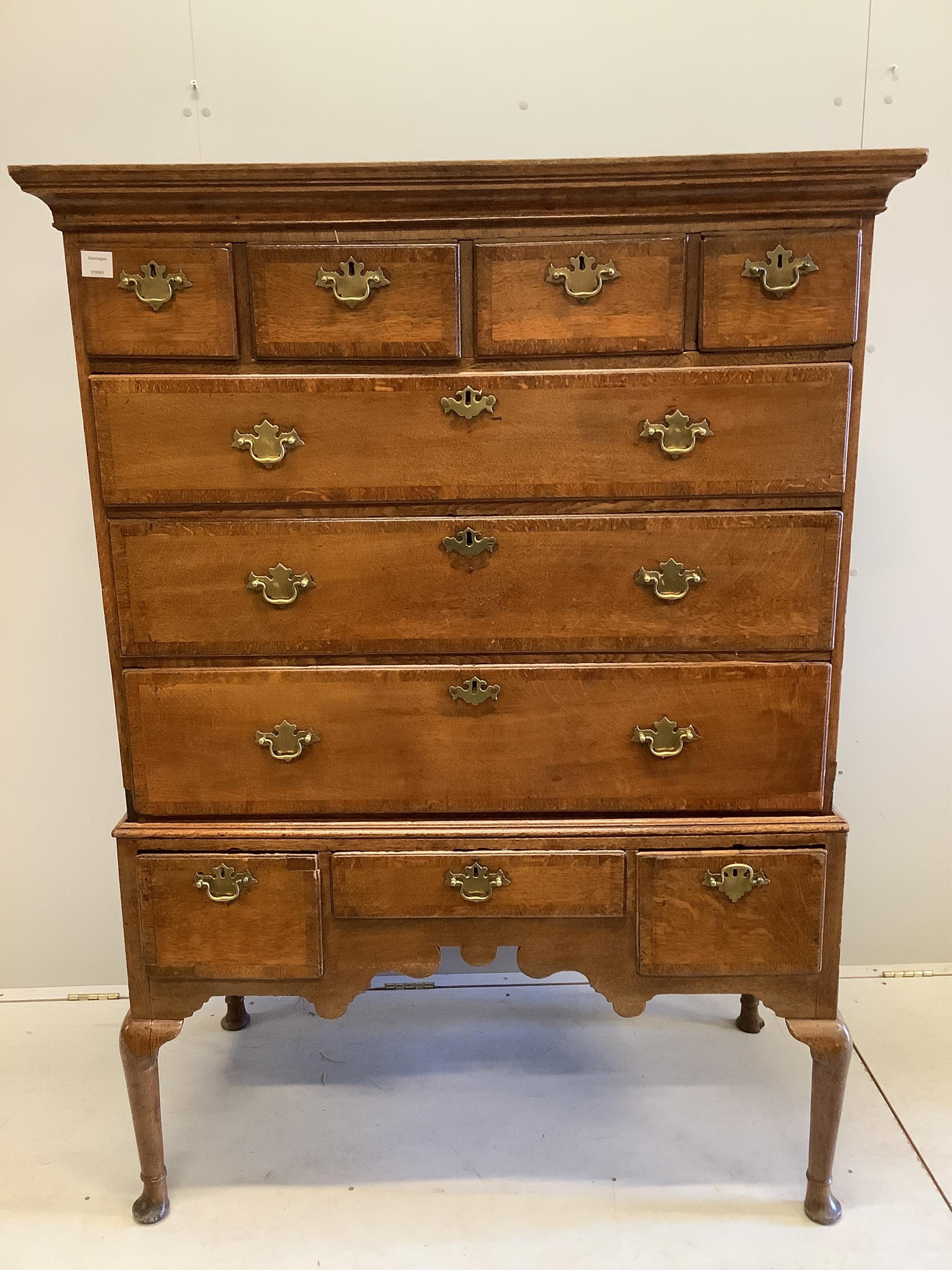 An 18th century banded oak chest on stand, width 114cm, depth 57cm, height 156cm